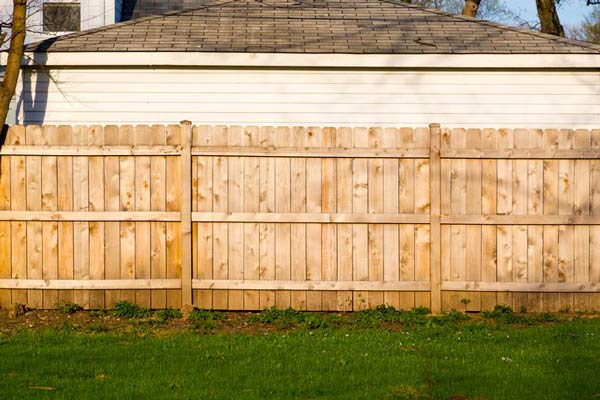 A Residential House Lawn Protected by a Solid Wooden Fence in Chicago, IL