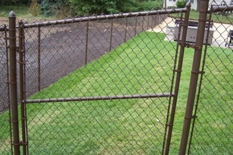 A yard in Batavia, IL features a chain link fence and a gate