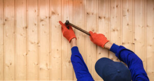 A Technician at a Lawn Area Installing Solid Wooden Fences in Chicago, IL
