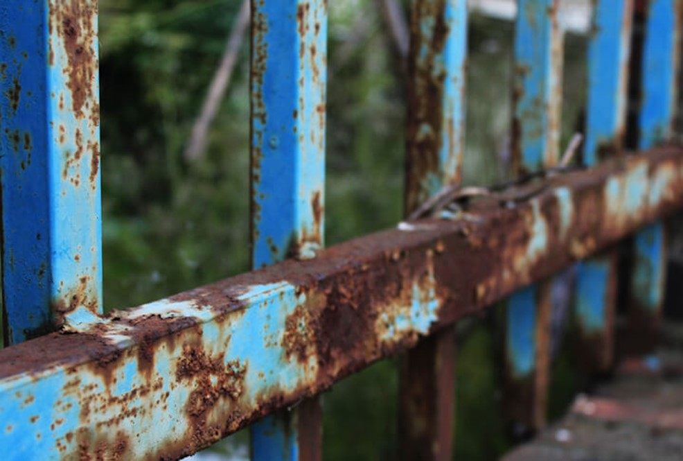 Close-up of rusting blue metal fence in Chicagoland Suburbs, IL