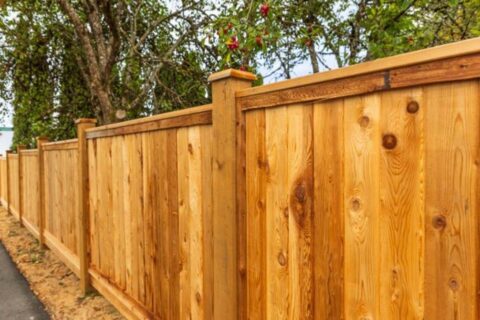 Cedar wood privacy fence with posts and caps along walkway, Chicago, IL